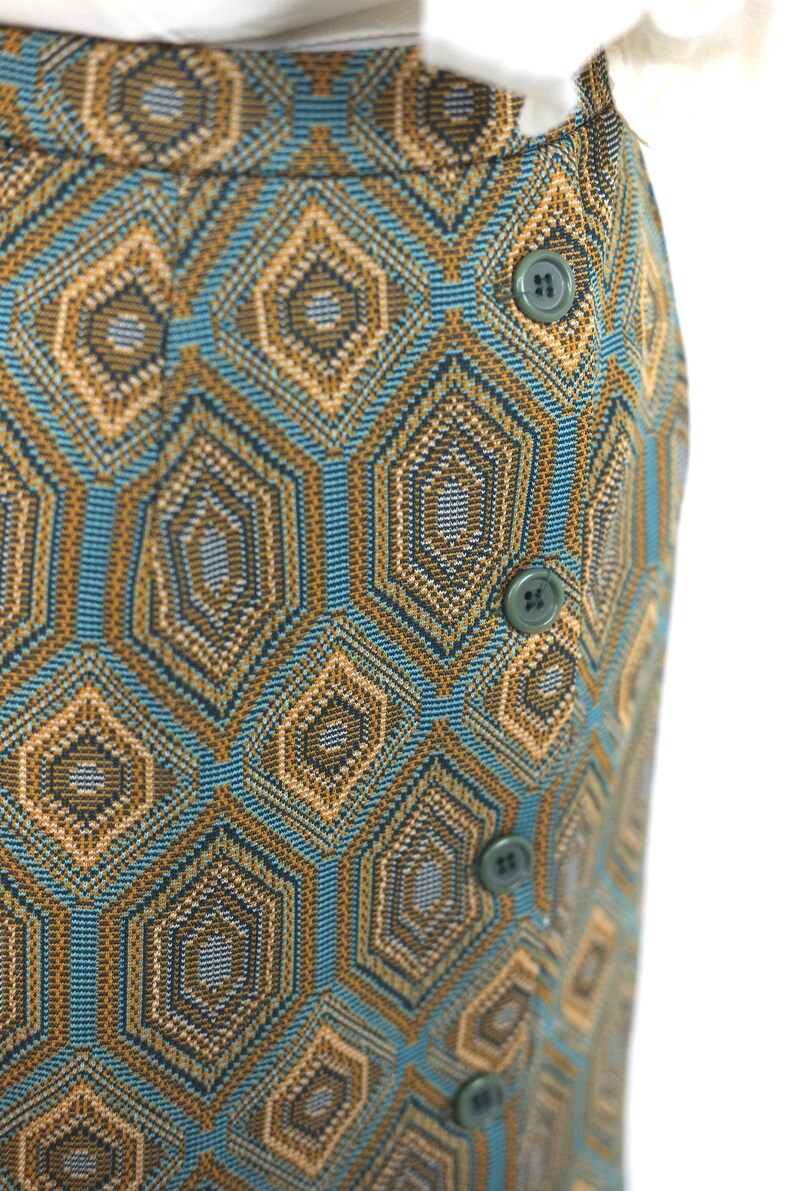 May include: A blue and brown skirt with a geometric pattern and button closures.