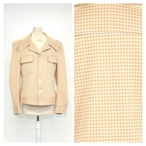 May include: A beige and white gingham patterned jacket with a long collar and two flap pockets.