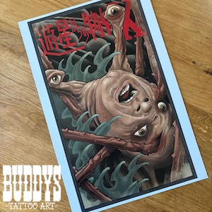 May include: A tattoo art print featuring a detailed illustration of a creature with multiple eyes and a wide open mouth. The artwork is in shades of brown, red, and blue, with Japanese text at the top. The print has a light blue border and the text "BUDDYS - TATTOO ART" at the bottom.