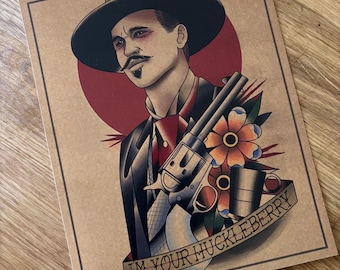 May include: Tattoo-style print featuring a man in a black hat and suit, holding a revolver. A red circle is behind the man's head. The words "IM YOUR HUCKLEBERRY" are on a banner below the image. A flower and a cup are also included.