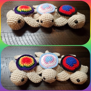May include: Three crocheted turtle amigurumi toys with different colored shells. The shells are rainbow, blue and white, and red and blue.