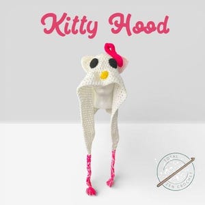 May include: A white crochet Kitty Hood with black eyes, a yellow nose, and a pink bow. The hood has long, braided ties with pink tassels. The words "Kitty Hood" are written in pink script above the hood.