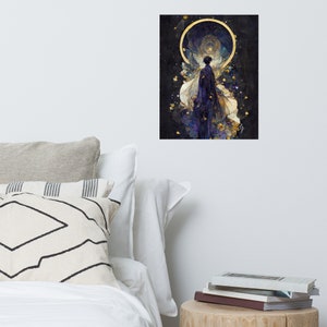 May include: An art print featuring a figure in a flowing gown, set against a dark background with a golden halo. The artwork uses shades of purple, blue, and gold, creating a celestial or ethereal theme. The print is displayed on a white wall.