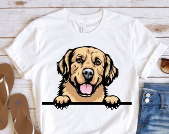 May include: White t-shirt with a cartoon image of a golden retriever dog peeking over the top of the shirt. The dog has a brown nose and tongue sticking out.