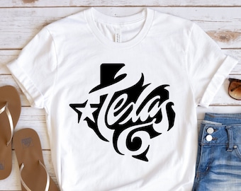May include: White t-shirt with a black graphic of the state of Texas with the word "Texas" stylized inside the outline. The graphic also includes a star.