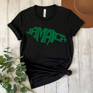 May include: Black t-shirt with a green outline of the word "Jamaica" in a retro style font.