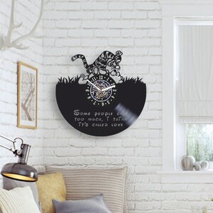 May include: Black vinyl record clock featuring a cartoon tiger with the quote "Some people care too much, I think it's called love."