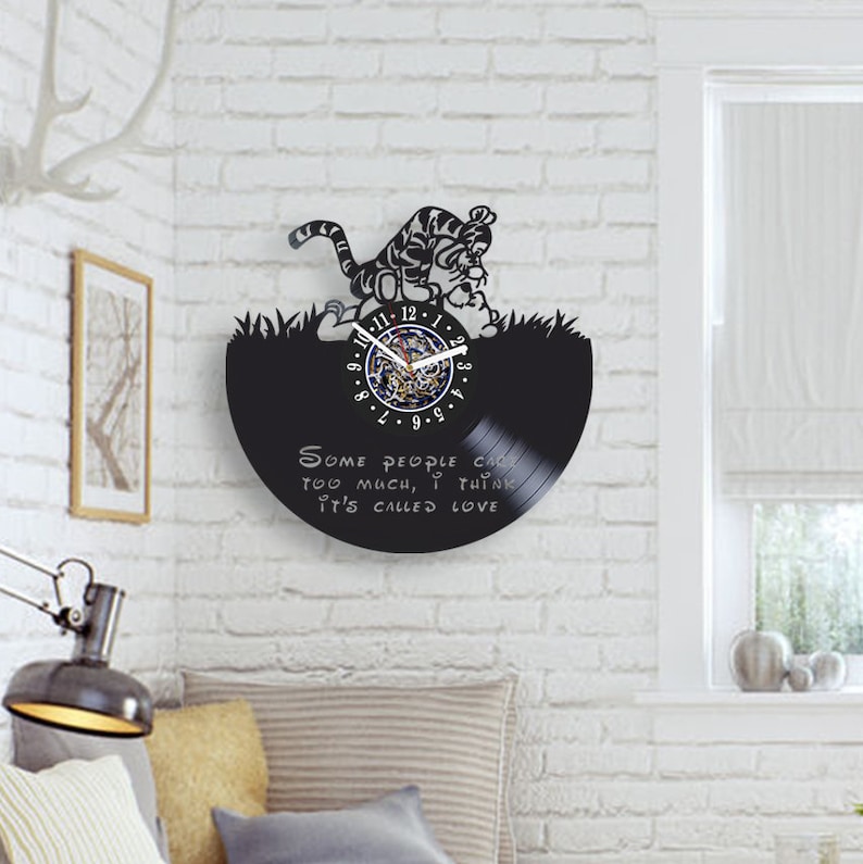 May include: Black vinyl record clock featuring a cartoon tiger with the quote "Some people care too much, I think it's called love."