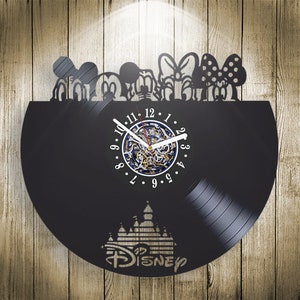May include: Black vinyl record clock featuring a silhouette of Mickey Mouse and friends, with a clock face and the word "DISNEY" in a stylized font.