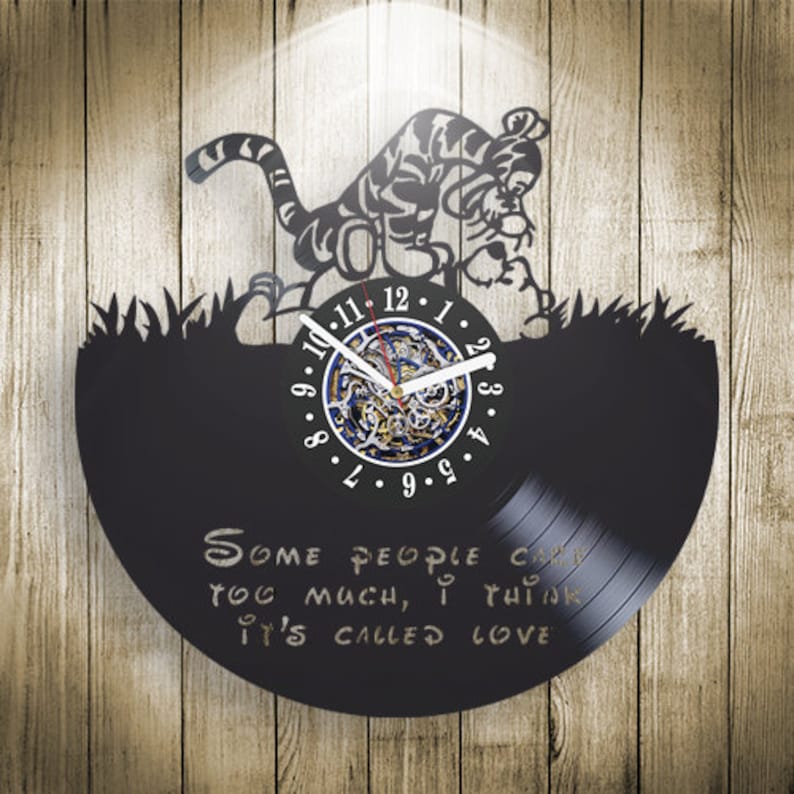 May include: Black vinyl record clock featuring a silhouette of a cartoon tiger with the quote "Some people can love you too much, I think it's called love".