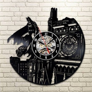 May include: Black vinyl record clock featuring a silhouette of Batman standing in front of Big Ben. The clock face is a white circle with black Roman numeral markings and a silver clock mechanism.
