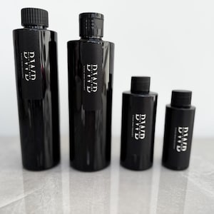 May include: Four black bottles with black labels and white text that reads "DIAD EVE" in different sizes.