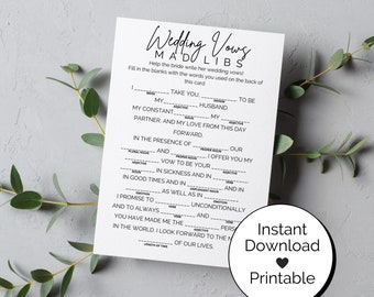 May include: A printable wedding vows mad libs game with a black and white design. The game includes fill-in-the-blank vows for the bride to use on her wedding day. The text on the card reads "Wedding Vows Mad Libs".