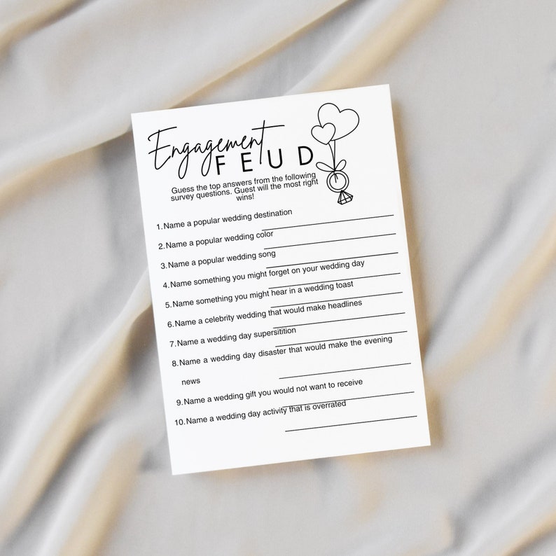 May include: A printable engagement game with the title "Engagement Feud". The game asks players to guess the top answers to ten wedding-related survey questions.