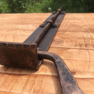 A 17&quot; door latch made of massive wrought iron, perfect for wooden doors. Mounted at the bottom, providing exceptional strength and security.