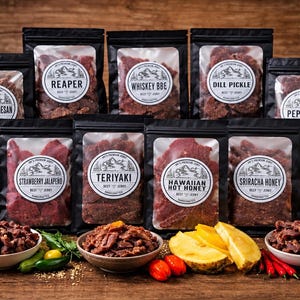 May include: A collection of nine black pouches of Jay's Premium Beef Jerky with clear windows, featuring labels for Garlic Parmesan, Reaper, Whiskey BBQ, Dill Pickle, Peppered, Strawberry Jalapeno, Teriyaki, Hawaiian Hot Honey, and Sriracha Honey.