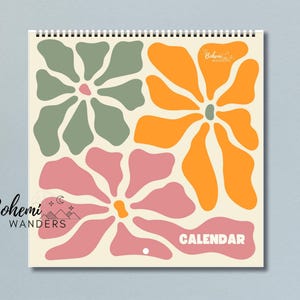 May include: A calendar with a floral design featuring three large flowers in shades of green, orange, and pink. The text "Bohemian Wanderers" and "CALENDAR" are printed on the front.