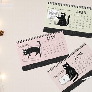 Funny 2025–2026 office cat desk calendar featuring black cats in relatable work situations. Minimalist design with sarcastic quotes for office workers, cat lovers, and coworkers. Great for desks, cubicles, or work-from-home setups. A humorous academic calendar gift for cat moms, students, and burnt-out professionals.
