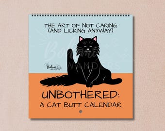 May include: A spiral-bound calendar with a black cat illustration. The cat is sitting with its rear end facing the viewer. The calendar has the text "THE ART OF NOT CARING (AND LICKING ANYWAY)" and "UNBOTHERED: A CAT BUTT CALENDAR".