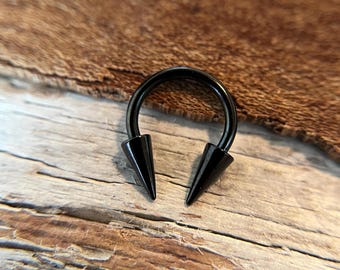 May include: Black circular barbell with two pointed ends. The barbell is made of metal and has a black finish.