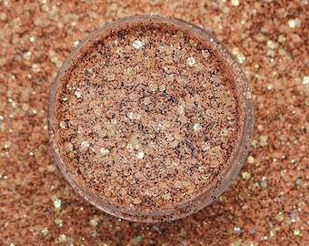 May include: A clear jar filled with fine copper glitter. The glitter is a mix of small and large iridescent flakes.