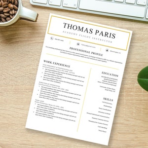 May include: A resume for Thomas Paris, an Academy Flight Instructor. The resume includes a professional profile, work experience, education, and skills sections. The resume is printed on white paper with a gold border.