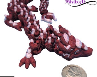 May include: A 3D-printed dragon figurine in shades of maroon and white. The dragon is posed with its body curled and its head facing forward. The text "Mistix3D" is visible in the upper right corner. The text "PHOTOS ARE EXAMPLES ONLY COLOR GRADIENT / PLACEMENT MAY VARY BY EACH MODEL" is visible at the bottom.