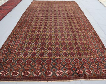 May include: A traditional Persian rug with a dark blue background and intricate geometric patterns in shades of red, gold, and cream. The rug has a fringed border.