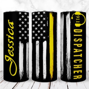 May include: A black tumbler with a design featuring a distressed American flag with a yellow stripe. The tumbler has the name "Jessica" in yellow script on one side and "911 DISPATCHER" with a headset graphic on the other.