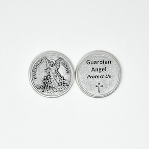 May include: Silver tone metal charm with an image of a guardian angel on one side and the text "Guardian Angel Protect Us" with a cross on the other side.