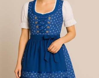 May include: A traditional blue dirndl dress with white floral patterns and a matching apron. The dress features a lace-trimmed neckline, decorative buttons, and a blue ribbon belt. The white blouse has short sleeves.