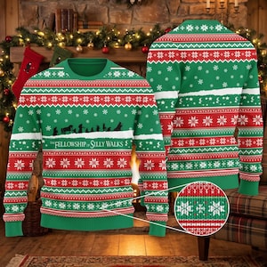 May include: A green, red, and white knit sweater featuring a repeating Nordic snowflake pattern and a central graphic of silhouettes walking in a line with the text "THE FELLOWSHIP OF SILLY WALKS" printed in white across the chest area.