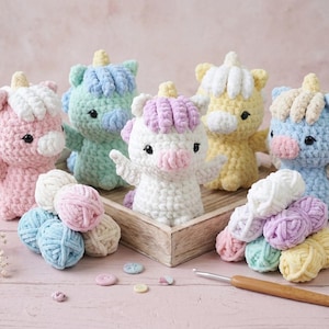 May include: A collection of handmade crochet unicorns in various pastel colors, including pink, blue, green, and yellow. The unicorns have white manes and wings, and are displayed with yarn balls and a crochet hook.