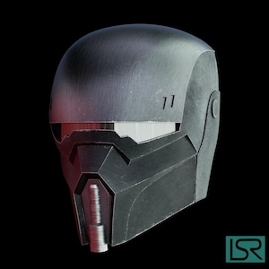May include: A metallic gray helmet with a futuristic design. The helmet features a visor, angular shapes, and a textured surface. The design includes a chin piece and small rectangular details near the top. The background is black.