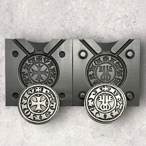 May include: Two sets of antique-style cabinet hardware. Each set includes a rectangular backplate with a circular, embossed design and a matching round knob. The hardware is made of a silver-toned metal.