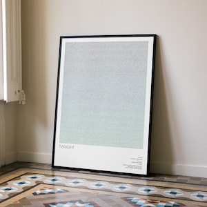 May include: A framed art print titled "Twilight" with a gradient of gray and blue hues. The artwork is displayed in a black frame and leans against a white wall. The print is in a room with a patterned tile floor.