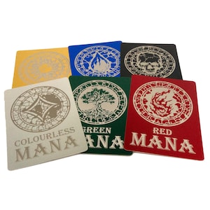 May include: A selection of rectangular game cards in various colours, including yellow, blue, black, green, and red. Each card features a unique circular design and the words "COLOURLESS MANA", "GREEN MANA", and "RED MANA".