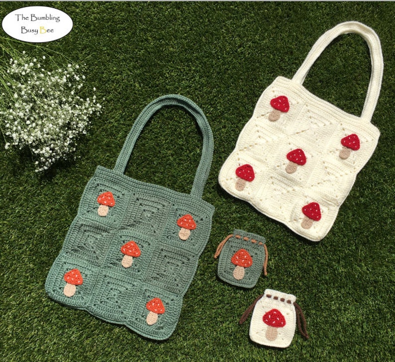 May include: Two crocheted tote bags with mushroom designs. One bag is green and the other is white. There are also two smaller crocheted bags with mushroom designs.