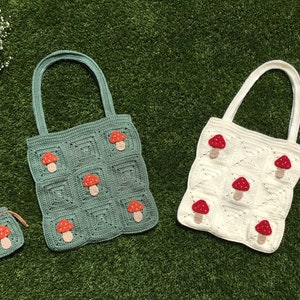 May include: Two crocheted tote bags with mushroom designs. The larger bag is green with red mushrooms and the smaller bag is white with red mushrooms. Both bags have matching drawstring pouches with red mushrooms.