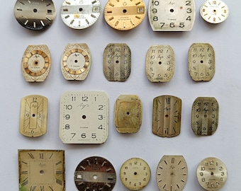 Könnte beinhalten: Eine Sammlung von 17 Vintage-Zifferblättern, die meisten mit römischen Ziffern, in verschiedenen Formen und Größen. Einige Zifferblätter sind gold, silber oder schwarz, mit weißen oder schwarzen Markierungen. Die Zifferblätter sind in einem Raster auf weißem Hintergrund angeordnet.