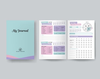 Può includere: Un diario blu chiaro con il testo "My Journal" e "Secret Garden" sulla copertina. Il diario è aperto a una pagina con un calendario e una sezione intitolata "Winter - Menstrual Phase". La pagina successiva ha un calendario e una sezione intitolata "Spring - Follicular Phase".