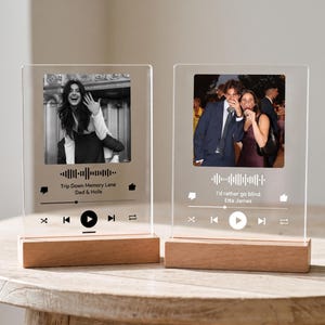 May include: Two clear acrylic rectangular plaques mounted on light wood bases. Each plaque features a printed photograph, a sound wave graphic, and music player interface icons. The left plaque displays text Trip Down Memory Lane Dad & Hoils.