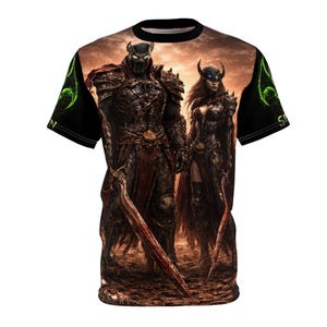 May include: A short-sleeved t-shirt featuring a detailed graphic of two armored figures with swords, set against a fiery, sepia-toned background. The design includes green accents on the sleeves and a black collar and sleeves. The overall theme is fantasy.