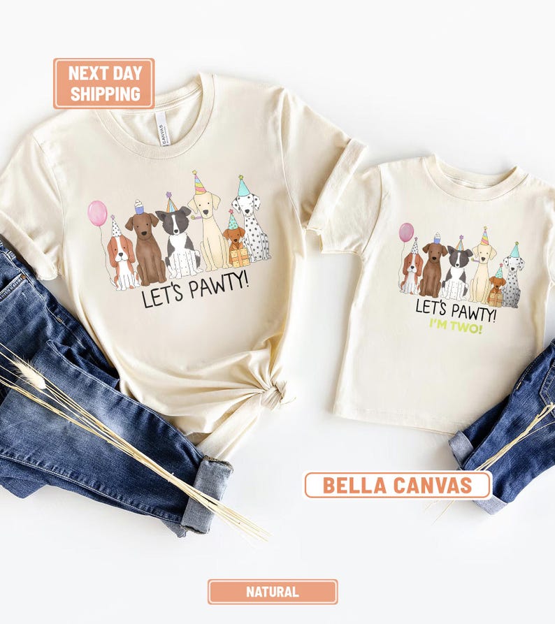 May include: Two natural-colored t-shirts with a dog-themed graphic. The larger shirt says "LET'S PAWTY!" and the smaller shirt says "LET'S PAWTY! I'M TWO!". The graphic features cartoon dogs wearing party hats and holding a balloon.