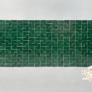 May include: Rectangular emerald green tiles arranged in a geometric pattern. The tiles are glossy and have a handmade appearance. The image includes the text "kesh TILES handmade" and "made in morocco".