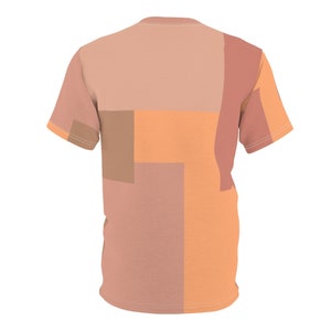 K&ouml;nnte beinhalten: Ein T-Shirt mit kurzen &Auml;rmeln und einem geometrischen Muster in den Farben Pfirsich, Orange und Braun.
