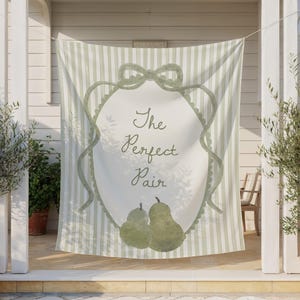 May include: A light green and white striped fabric banner with the text "The Perfect Pair" in script. The banner features a watercolor design of two pears and a decorative frame with a bow.