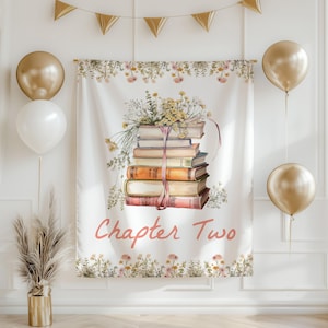 May include: A white backdrop with a stack of books tied with a pink ribbon and surrounded by flowers. The text "Chapter Two" is written in pink below the books.