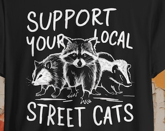 Maglietta "Sostieni i gatti randagi della tua zona" / Maglietta divertente con procioni, puzzole e opossum / Maglietta con animali selvatici urbani / Regalo per amanti degli animali / Umorismo sui procioni