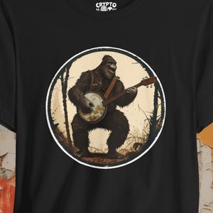 Sasquatch Banjo T-shirt Bigfoot Bluegrass Tee Cryptid Music Shirt Gift for Folk Music Fans Mothman and Cryptid Art Lovers